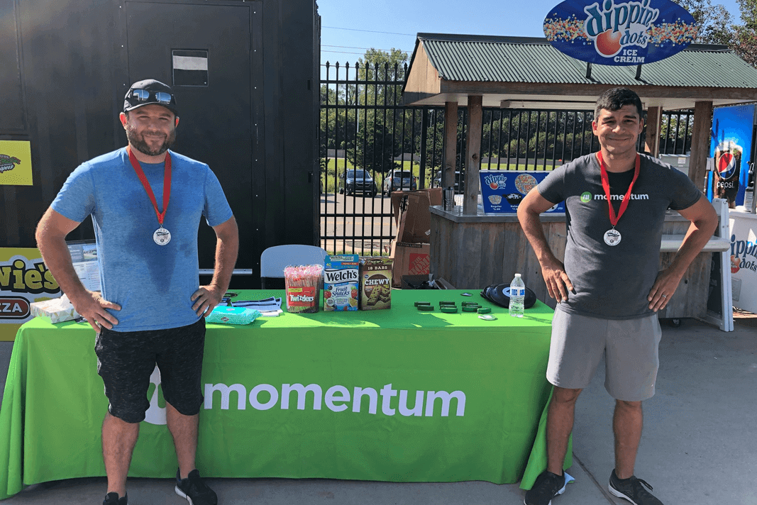 Momentum team members at Momentum booth for 5K Pennant Race hosted by Kiwanis Club of Utica-Shelby Township