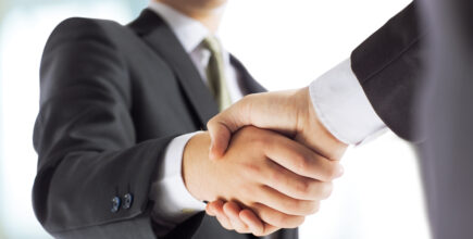 business and office concept - businessman shaking hands with each other
