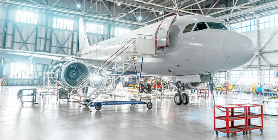 Aircraft under maintenance, checking mechanical systems for flight operations. Plane in the hangar