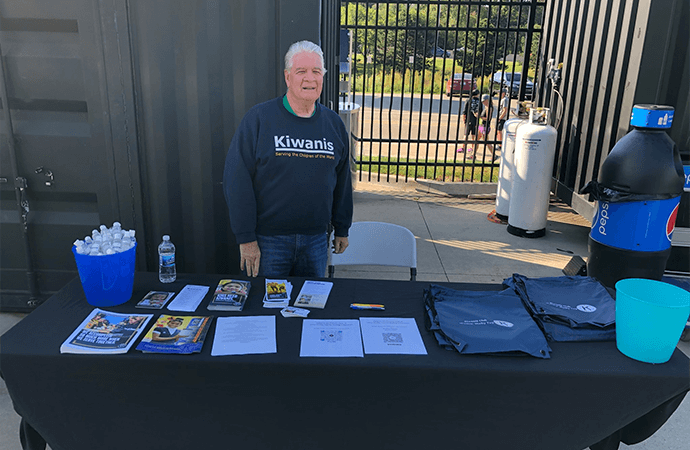 Kiwanis Club member and booth at the Jimmy John's 5K