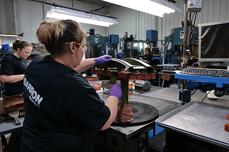 Two Barron Industries employees working with wax parts