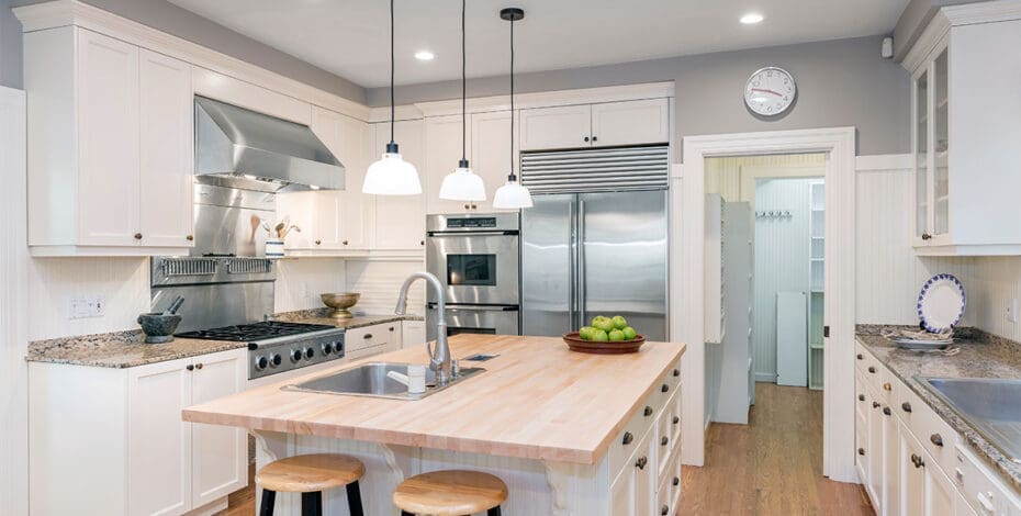 Amazing Luxury Kitchen Interior in white with wooden floor and kitchen island.