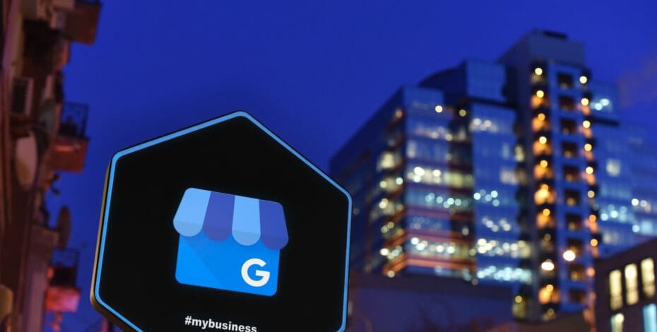 Google My Business sign with cityscape at night
