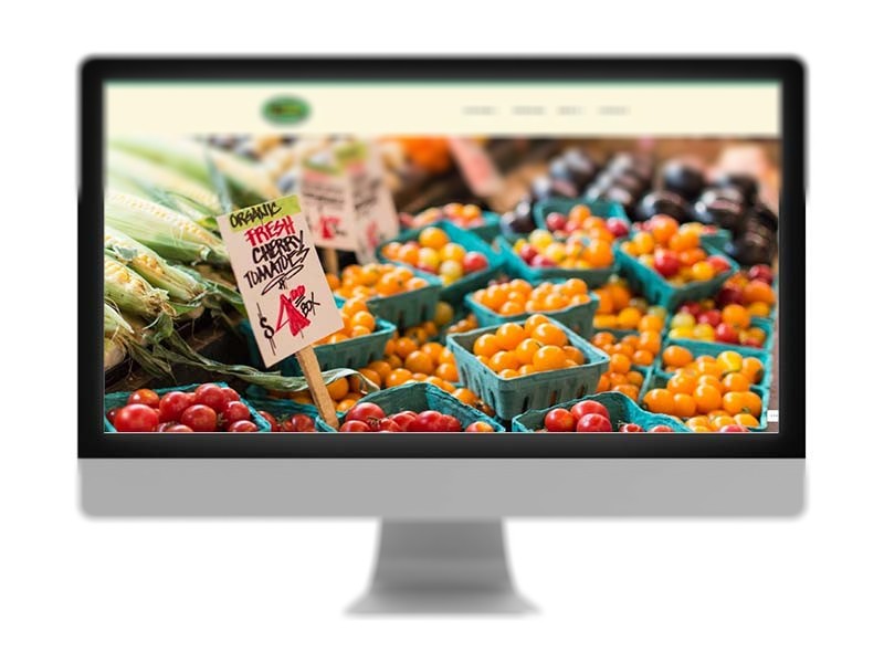 The hero image of a local farmers market which features high-quality imagery of fresh cherry tomatoes, but doesn't include a call to action