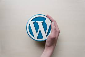 A hand cupped around the WordPress logo